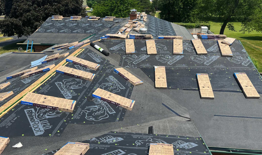 cw roofing applying underlayment to roof deck - contact today
